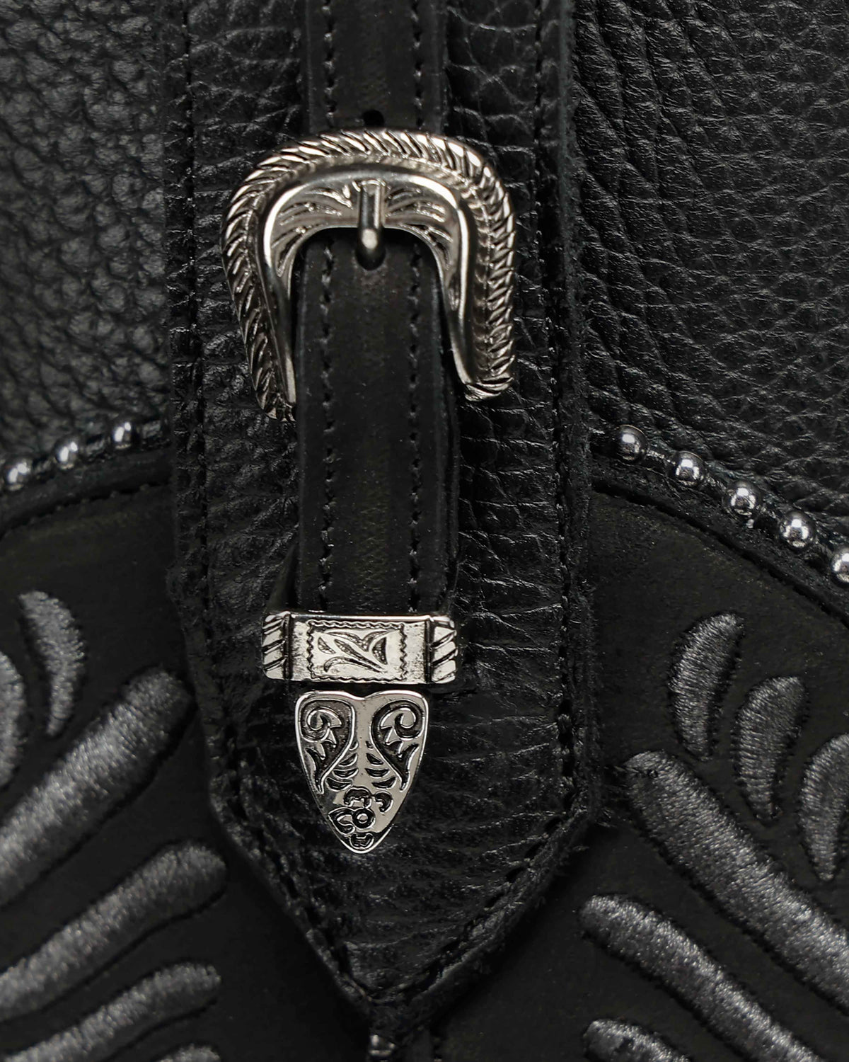 Close-up of the high-relief embroidery on the Cuadra CC476 black leather boot