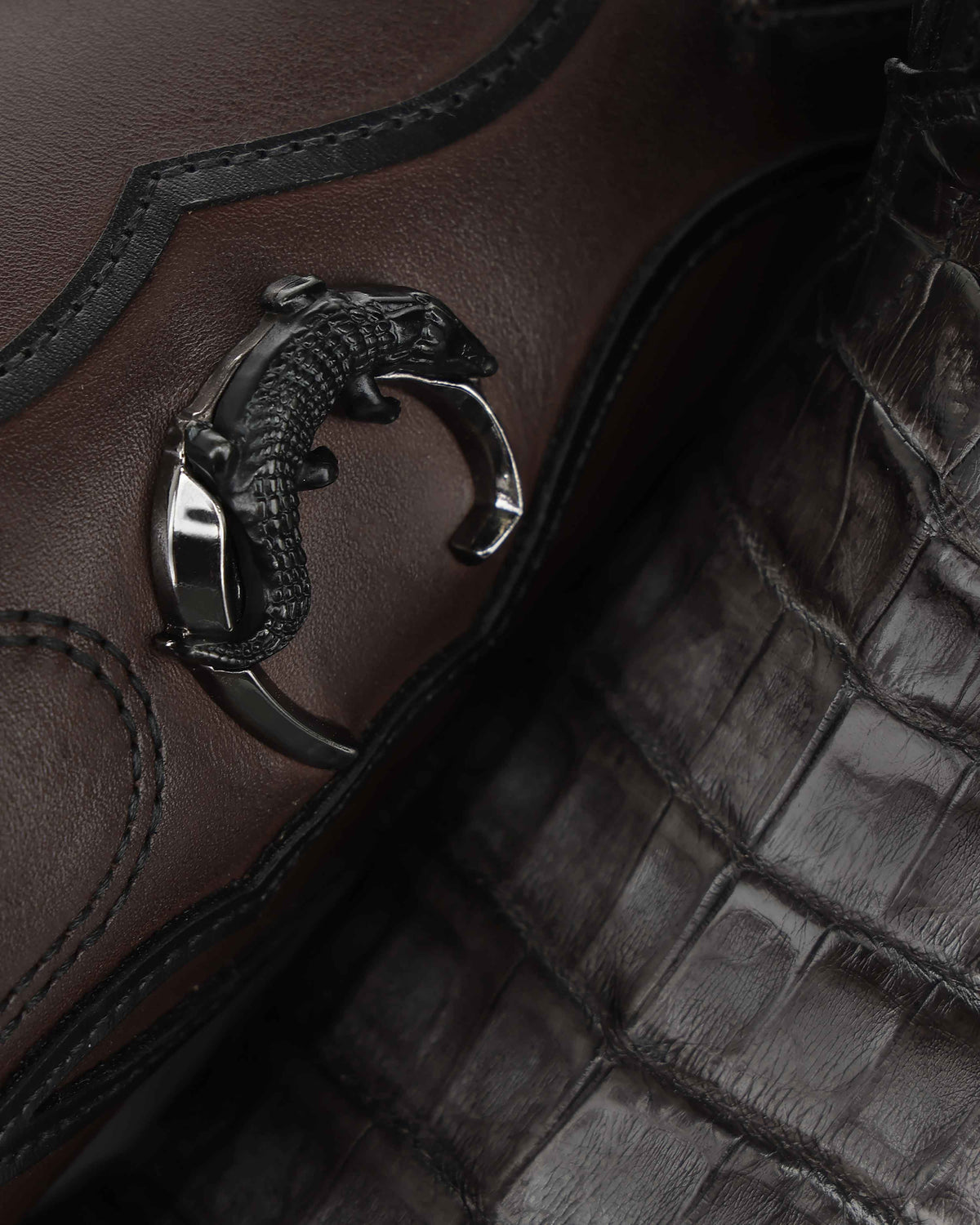 Detail of the metal Cuadra monogram on the CC353 caiman boot shaft