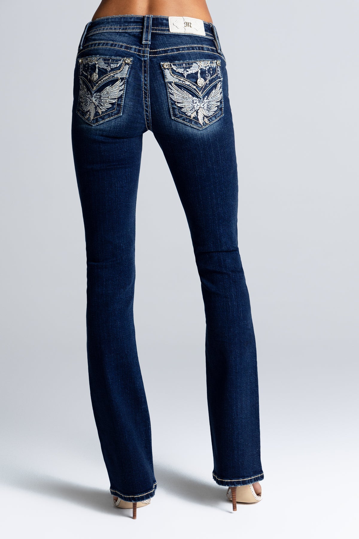 Miss Me Gypsy bootcut jean M3080B96V, close-up of the embroidered leather wing applique on the back pocket