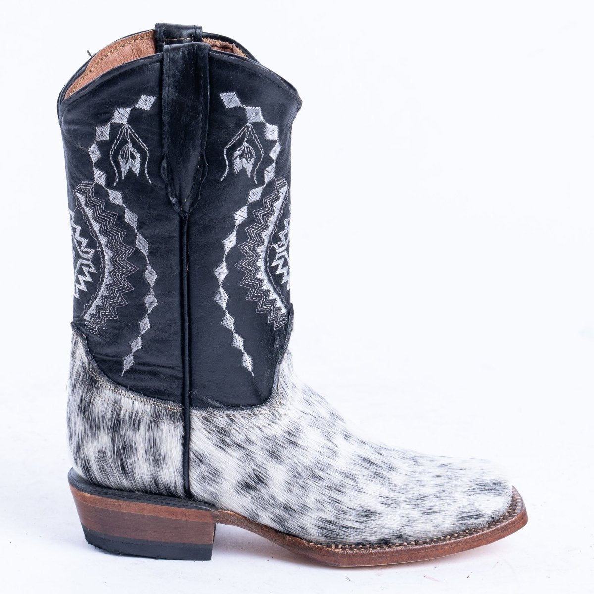Tanner Mark Cash TMK205323 kids boot, side view of the black and white hair-on cowhide foot and square toe
